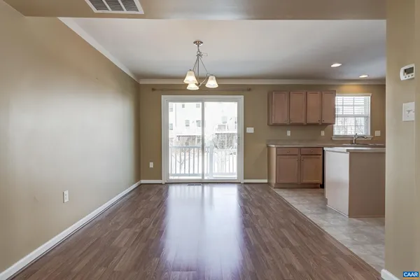 a open kitchen with cabinets wooden floor and a fireplace