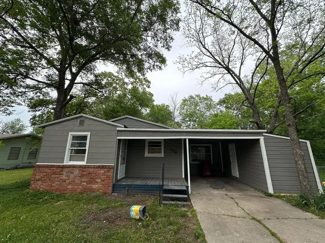 a front view of house with yard and green space