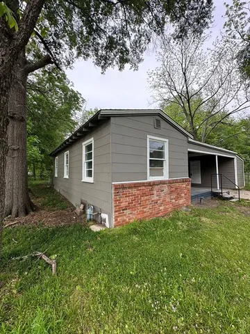 a front view of house with a garden