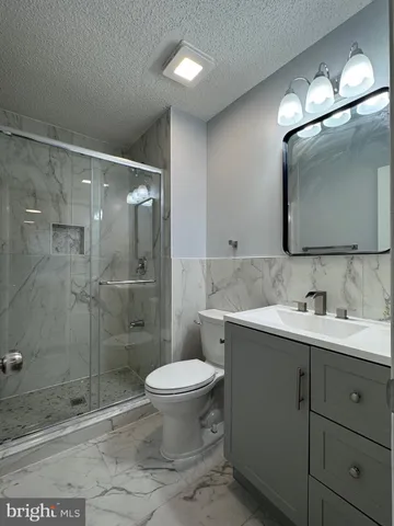 a bathroom with a toilet sink and shower
