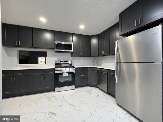 a kitchen with a refrigerator stove and microwave