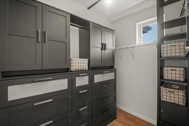 a kitchen with granite countertop a refrigerator and a cabinets