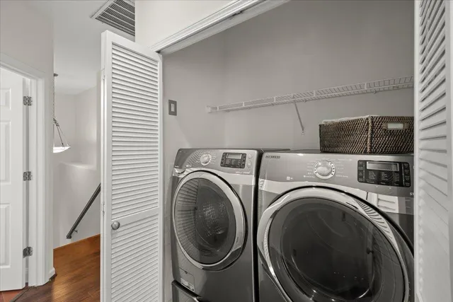 a view of a hallway with washer and dryer