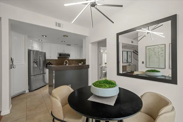 a kitchen with a table and chairs