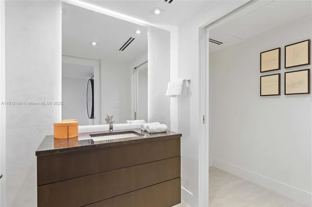 a living room with furniture and a book shelf