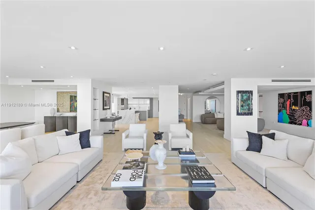 a bedroom with a large bed and paintings on the wall