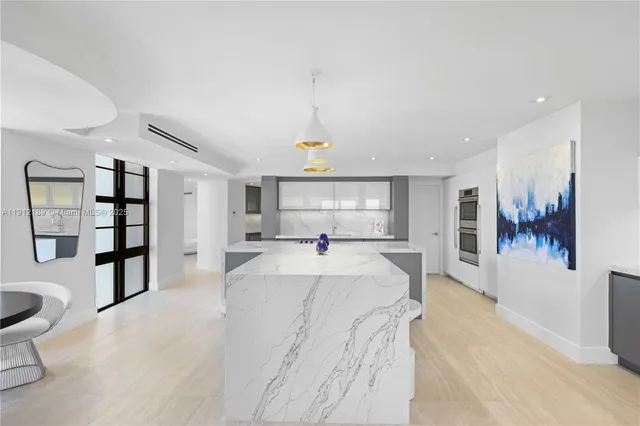 a large white room with a large mirror and shower