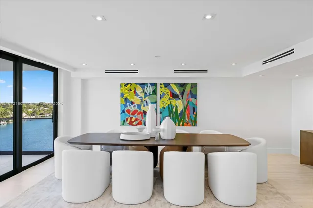 a living room with furniture and floor to ceiling windows