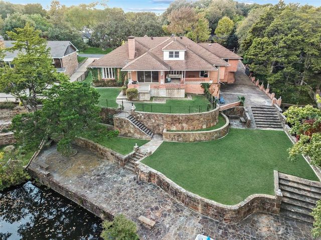 a front view of a house with a yard and green space