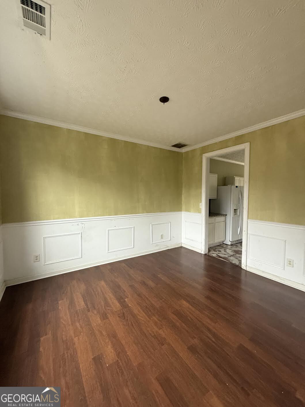 965 Trotters Farm Road Fairburn, GA 30213 - Photo 3 of 6 an empty room with wooden floor and windows
