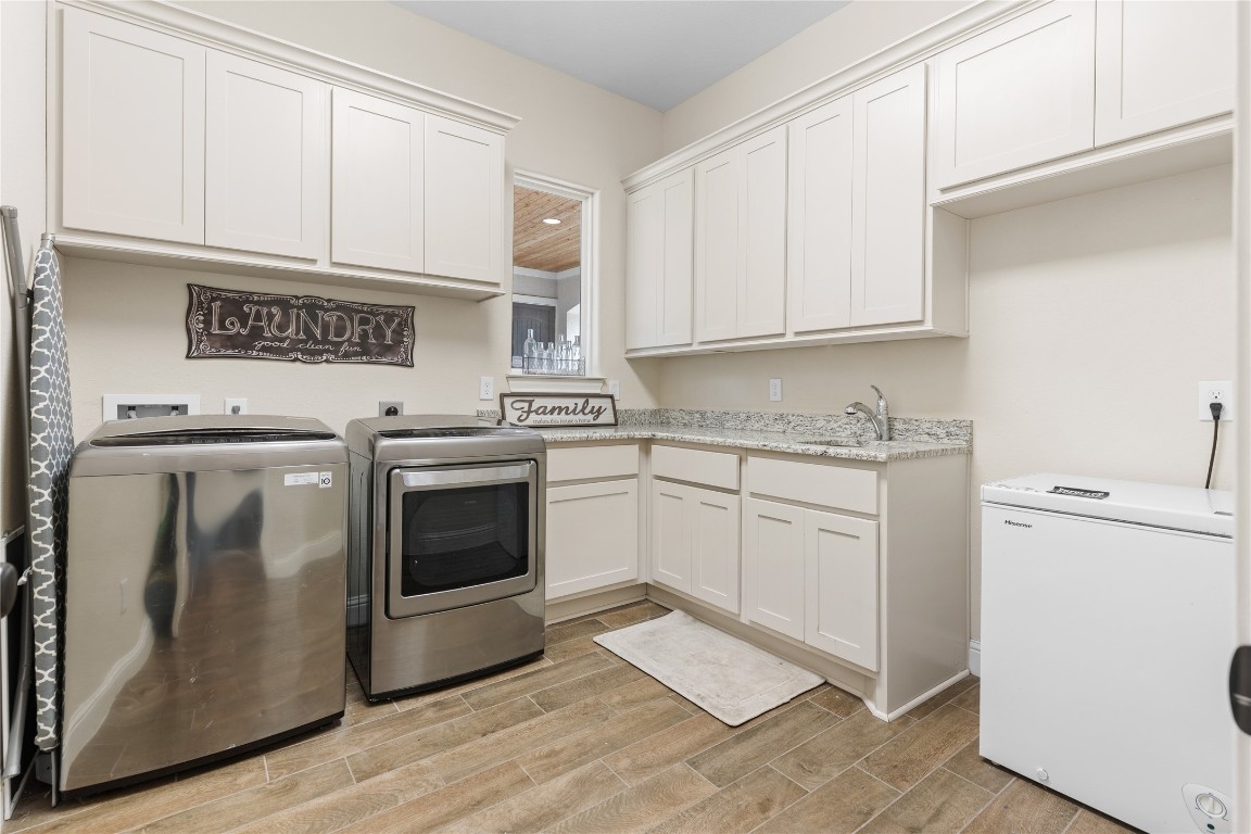 141 Sundog Road Huntsville, TX 77340 - Photo 11 of 49 a kitchen with granite countertop white cabinets and white appliances