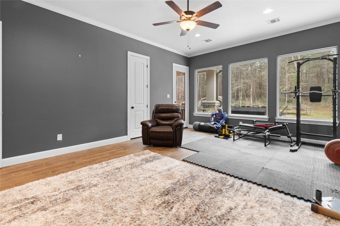 141 Sundog Road Huntsville, TX 77340 - Photo 14 of 49 a living room with furniture a flat screen tv and a large window