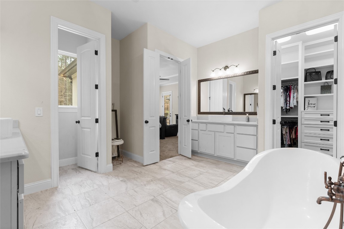 141 Sundog Road Huntsville, TX 77340 - Photo 19 of 49 a large white kitchen with a sink and cabinets