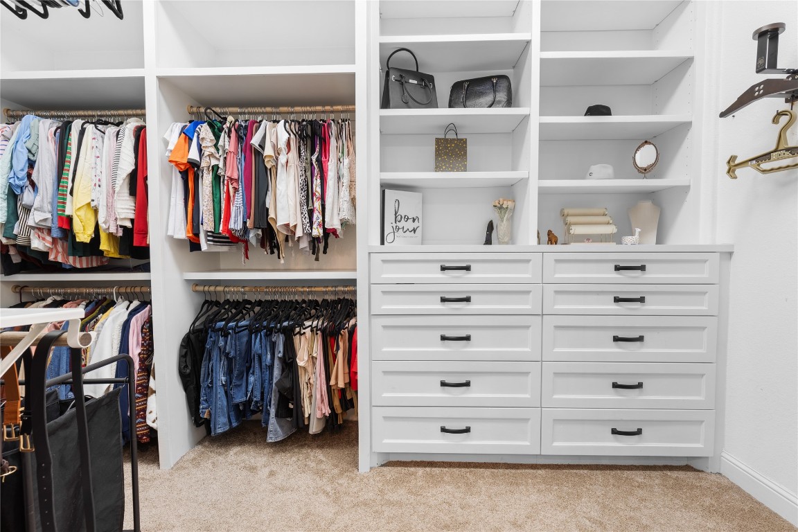 141 Sundog Road Huntsville, TX 77340 - Photo 21 of 49 a view of walk in closet with clothes and shoes