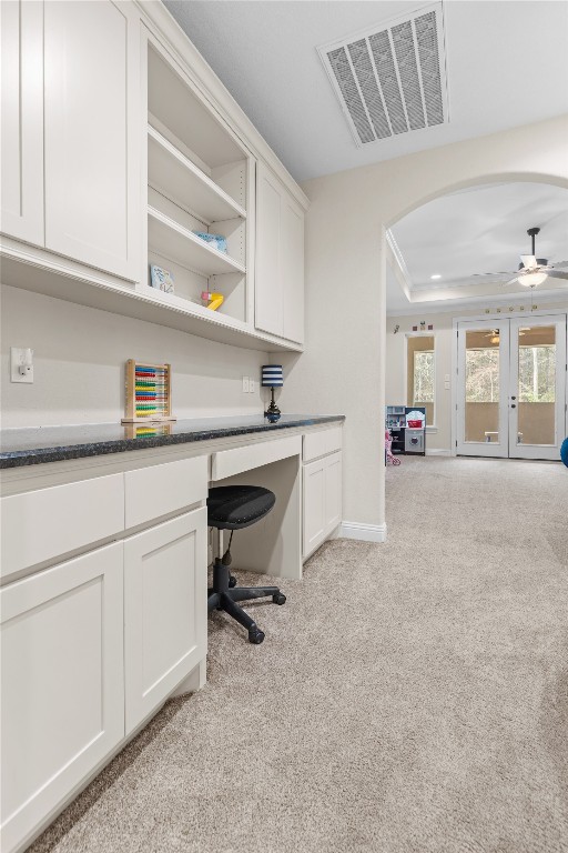 141 Sundog Road Huntsville, TX 77340 - Photo 23 of 49 a kitchen with a white cabinets and chairs