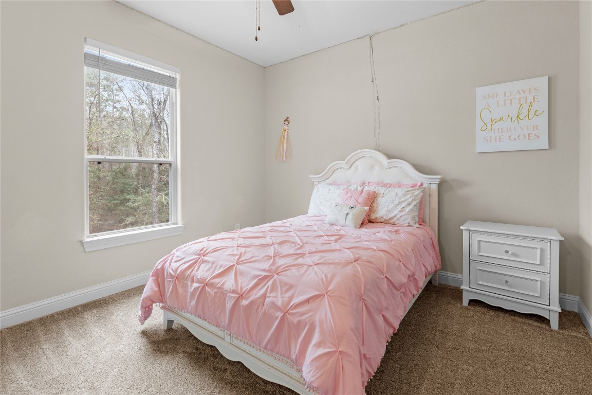 141 Sundog Road Huntsville, TX 77340 - Photo 27 of 49 a bedroom with a bed and a window