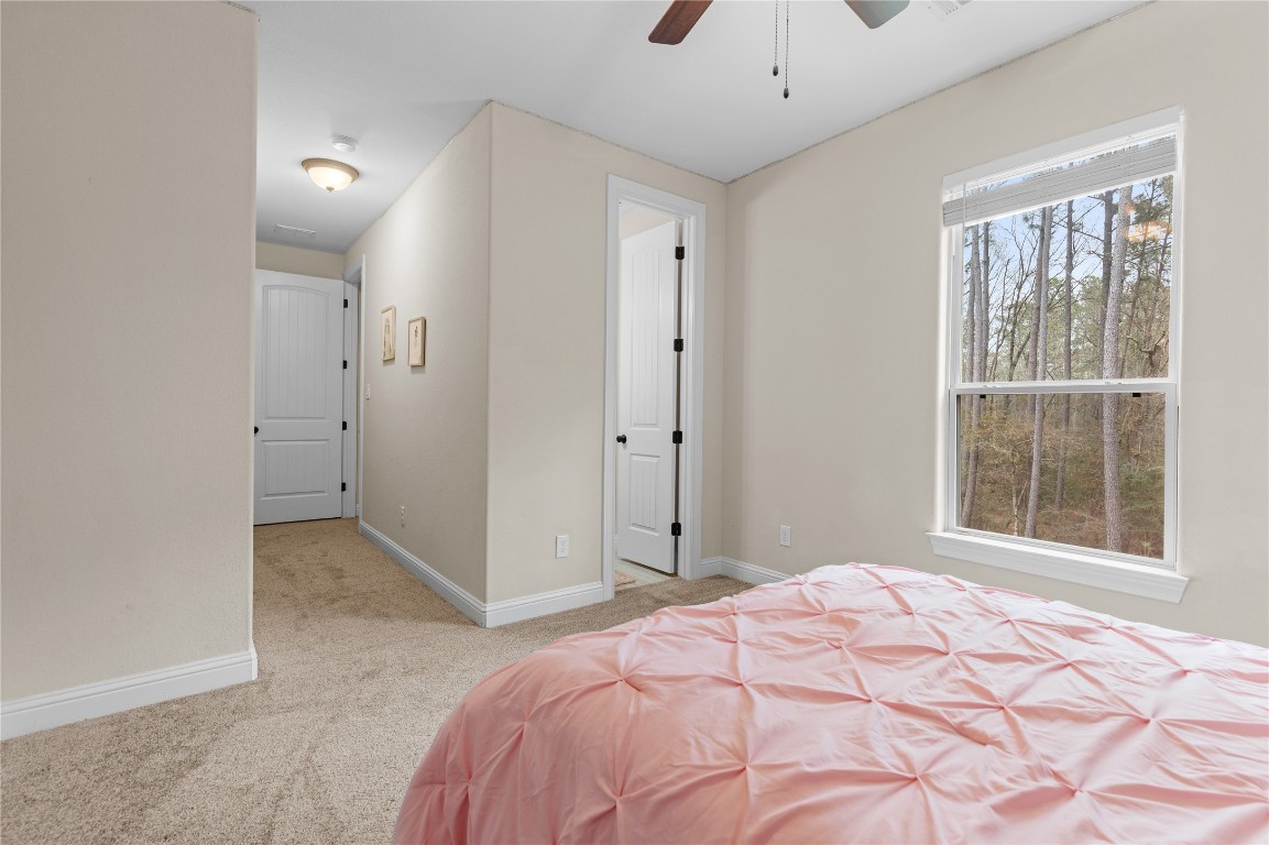 141 Sundog Road Huntsville, TX 77340 - Photo 28 of 49 a bedroom with a bed and a window