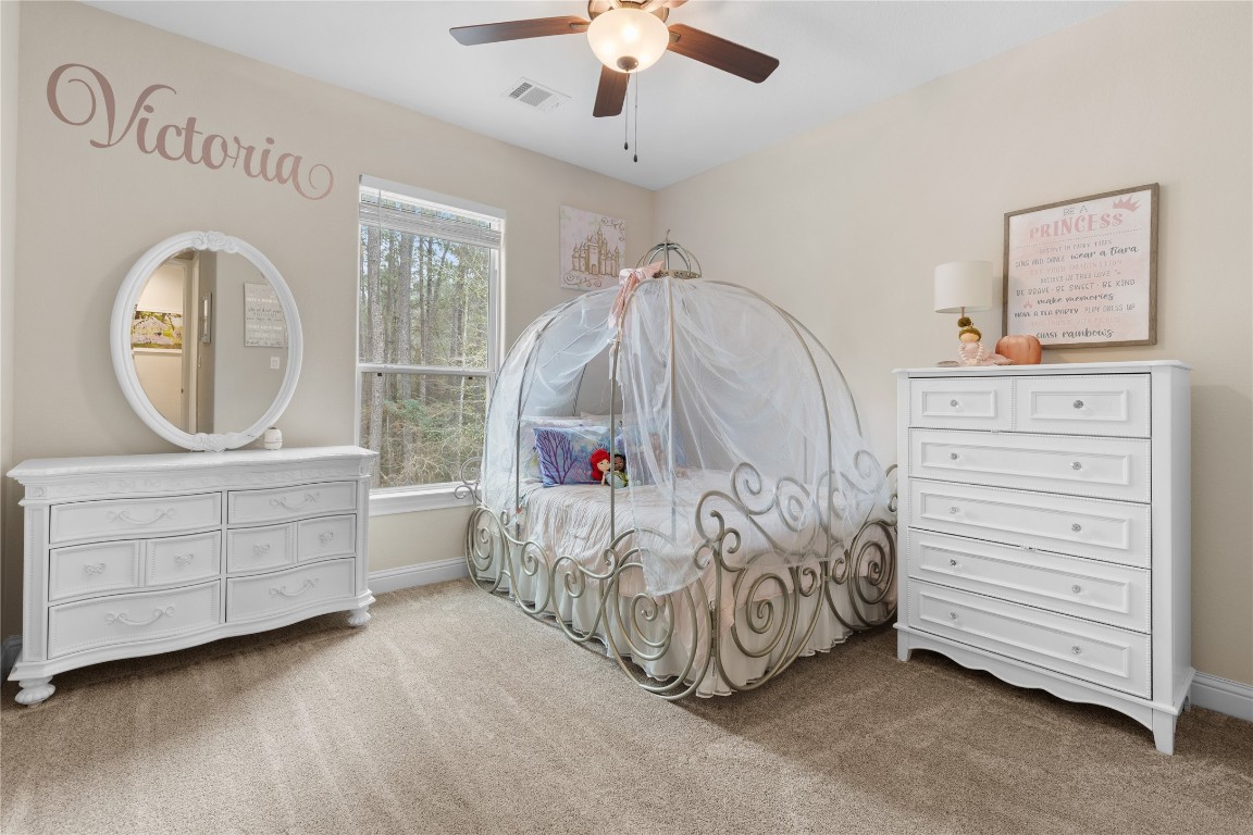 141 Sundog Road Huntsville, TX 77340 - Photo 30 of 49 a view of a bedroom with baby crib and a dresser