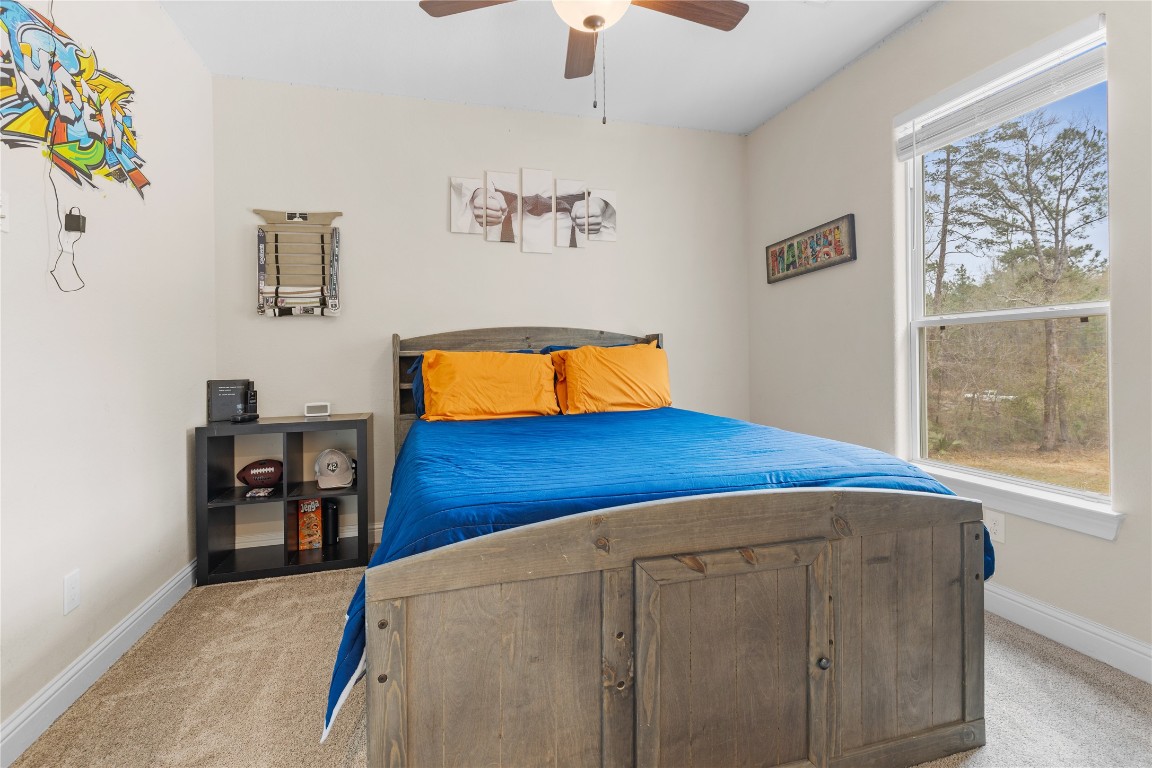 141 Sundog Road Huntsville, TX 77340 - Photo 31 of 49 a living room with blue wall painting and a dining table