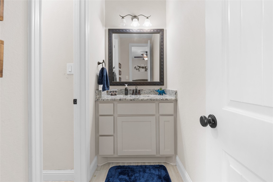 141 Sundog Road Huntsville, TX 77340 - Photo 32 of 49 a bathroom with a sink vanity and a mirror