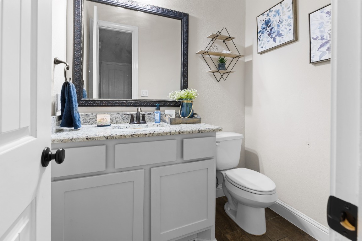 141 Sundog Road Huntsville, TX 77340 - Photo 35 of 49 a bathroom with a toilet sink and mirror