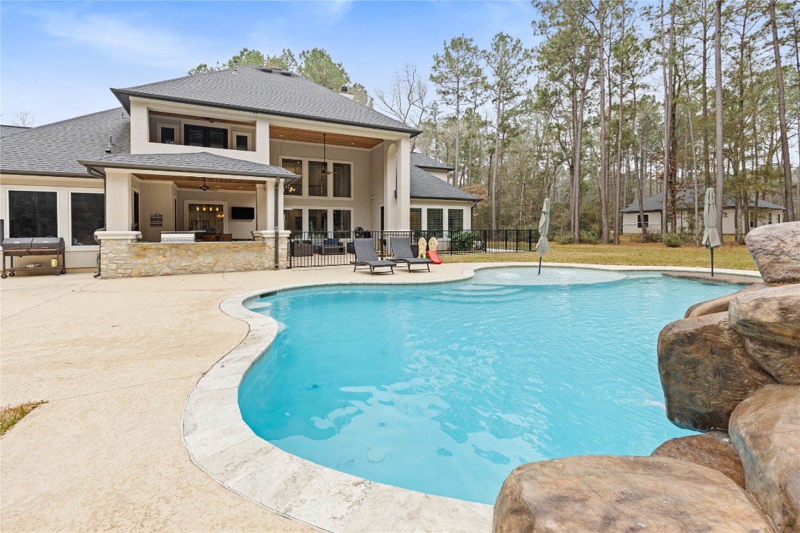 141 Sundog Road Huntsville, TX 77340 - Photo 38 of 49 a view of a house with swimming pool and sitting area