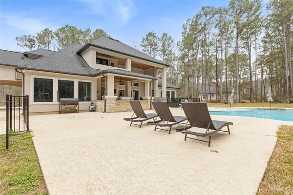 a view of a house with swimming pool and sitting area