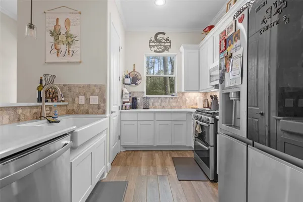 a kitchen with cabinets and stainless steel appliances
