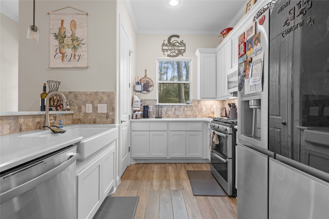141 Sundog Road Huntsville, TX 77340 - Photo 42 of 49 a kitchen with cabinets and stainless steel appliances