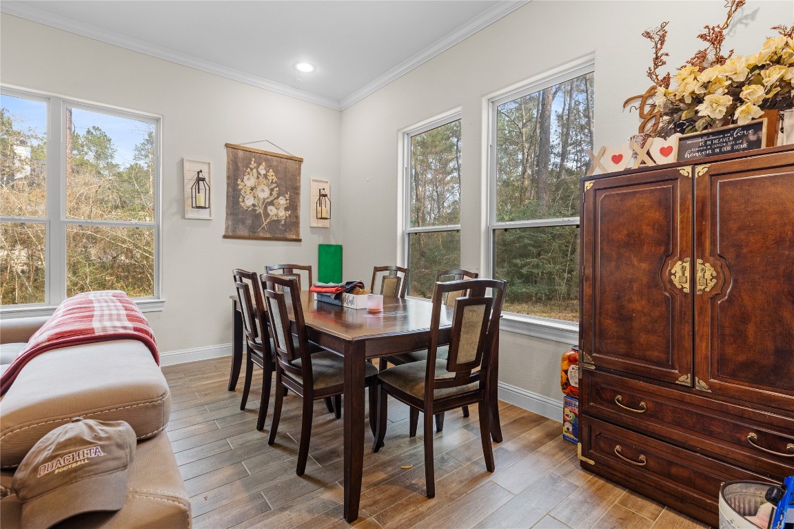 141 Sundog Road Huntsville, TX 77340 - Photo 43 of 49 a view of a dining room with furniture window and wooden floor
