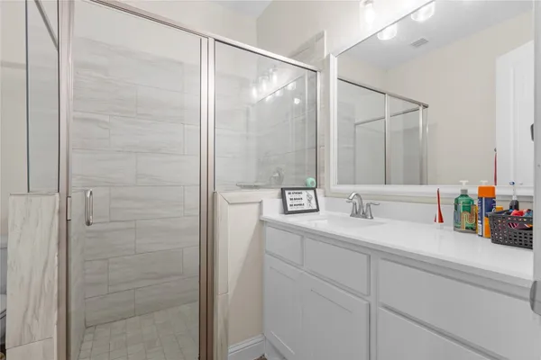 a bathroom with a double vanity sink and a mirror