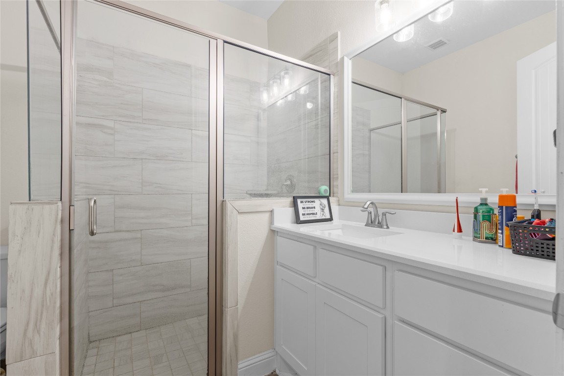 141 Sundog Road Huntsville, TX 77340 - Photo 46 of 49 a bathroom with a double vanity sink and a mirror