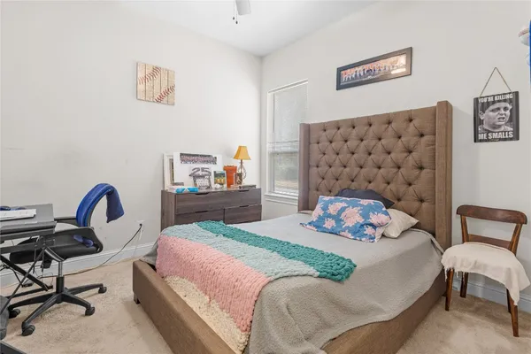 a bedroom with a bed and a chair