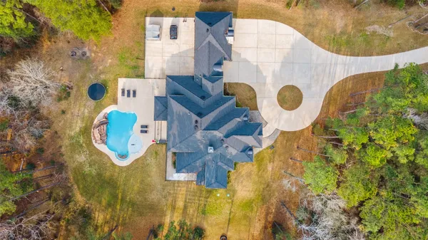 an aerial view of residential house with pool and yard