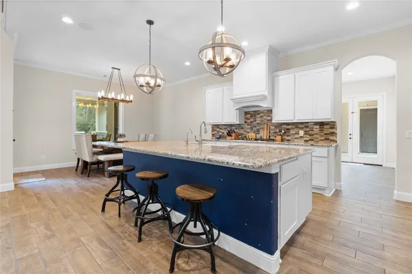 a kitchen with sink cabinets and dining table