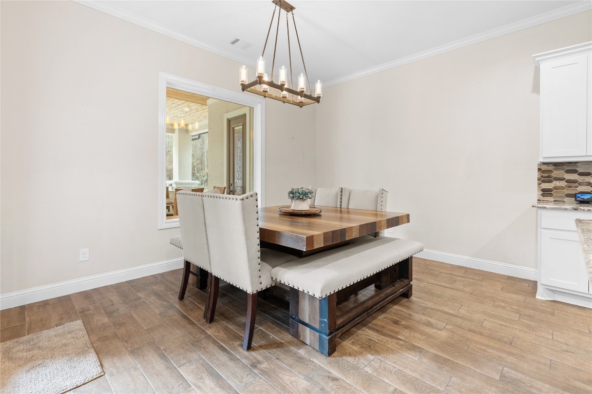 141 Sundog Road Huntsville, TX 77340 - Photo 9 of 49 a view of a room that has a table and chairs in it