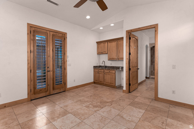 2464 East Granite Way St. George, UT 84790 - Photo 84 of 106 Guest suite with kitchenette, lofted ceiling, ceiling fan, recessed lighting, dark stone countertops, and arched walkways