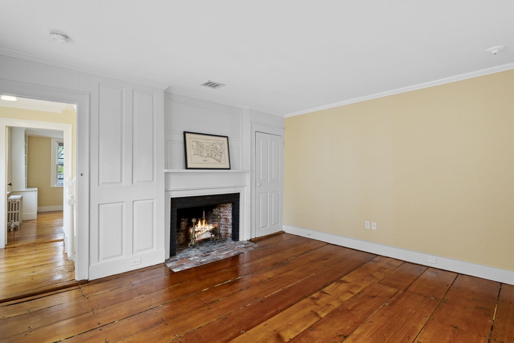 112 Federal Street, Unit 1 Salem, MA 01970 - Photo 17 of 42 a living room with wooden floor and a fireplace
