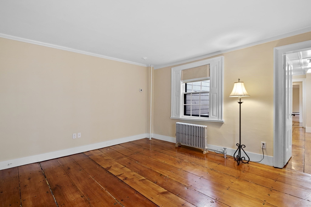 112 Federal Street, Unit 1 Salem, MA 01970 - Photo 18 of 42 wooden floor in an empty room with a window