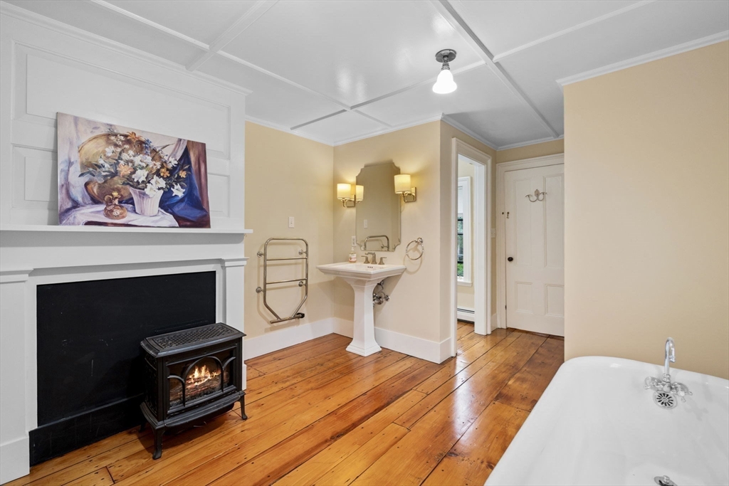 112 Federal Street, Unit 1 Salem, MA 01970 - Photo 19 of 42 a bedroom with furniture and a fireplace