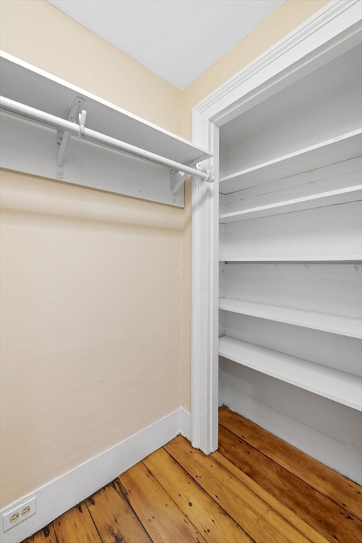 112 Federal Street, Unit 1 Salem, MA 01970 - Photo 26 of 42 a view of walk in closet with empty racks