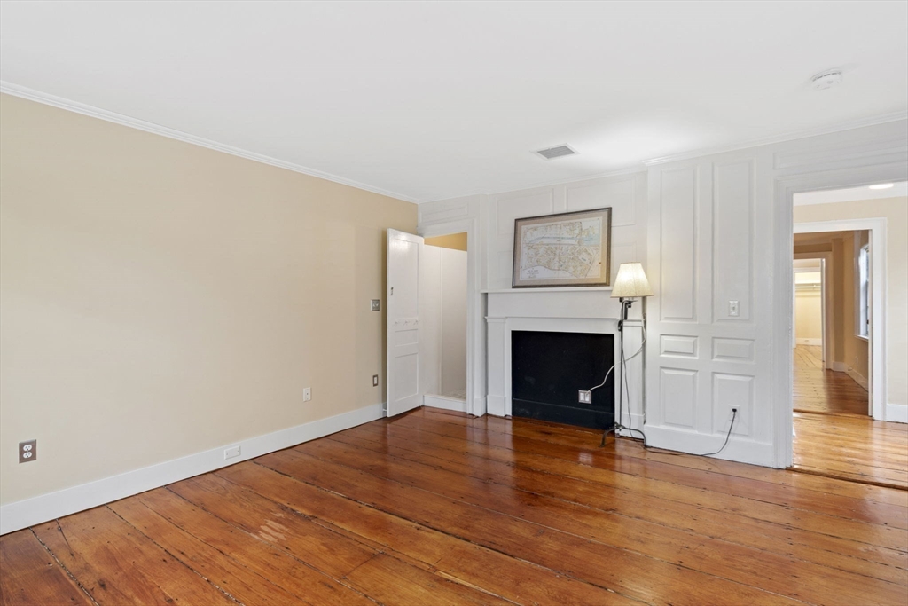 112 Federal Street, Unit 1 Salem, MA 01970 - Photo 27 of 42 a view of empty room with wooden floor and fireplace