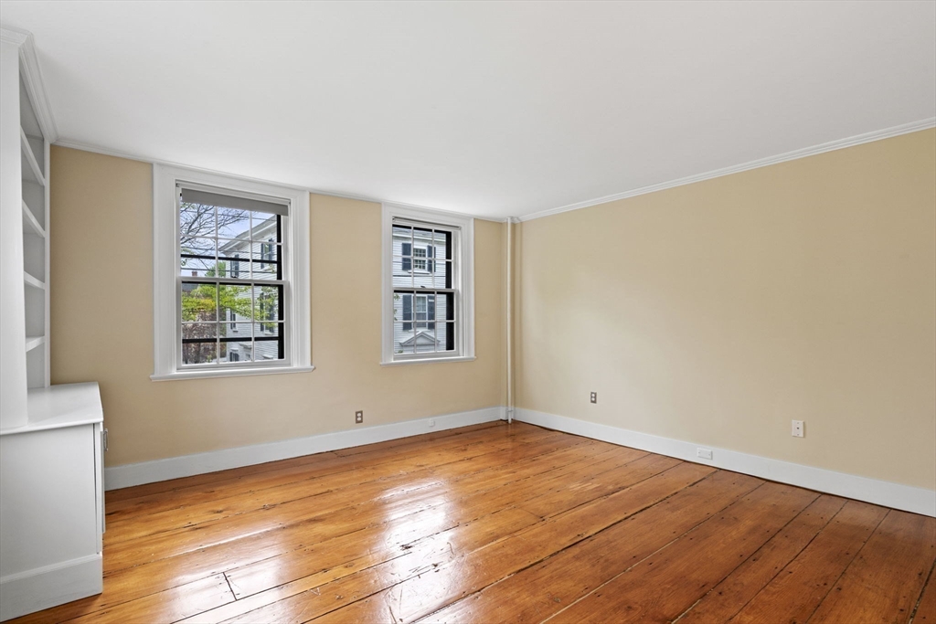 112 Federal Street, Unit 1 Salem, MA 01970 - Photo 30 of 42 an empty room with wooden floor and windows
