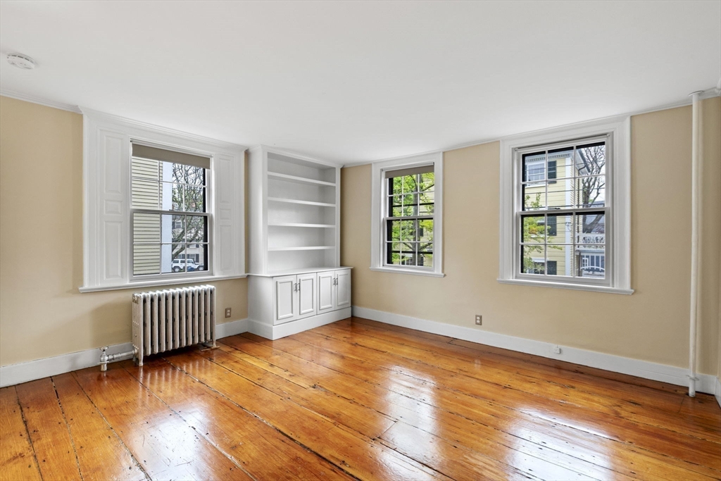 112 Federal Street, Unit 1 Salem, MA 01970 - Photo 31 of 42 an empty room with wooden floor and windows