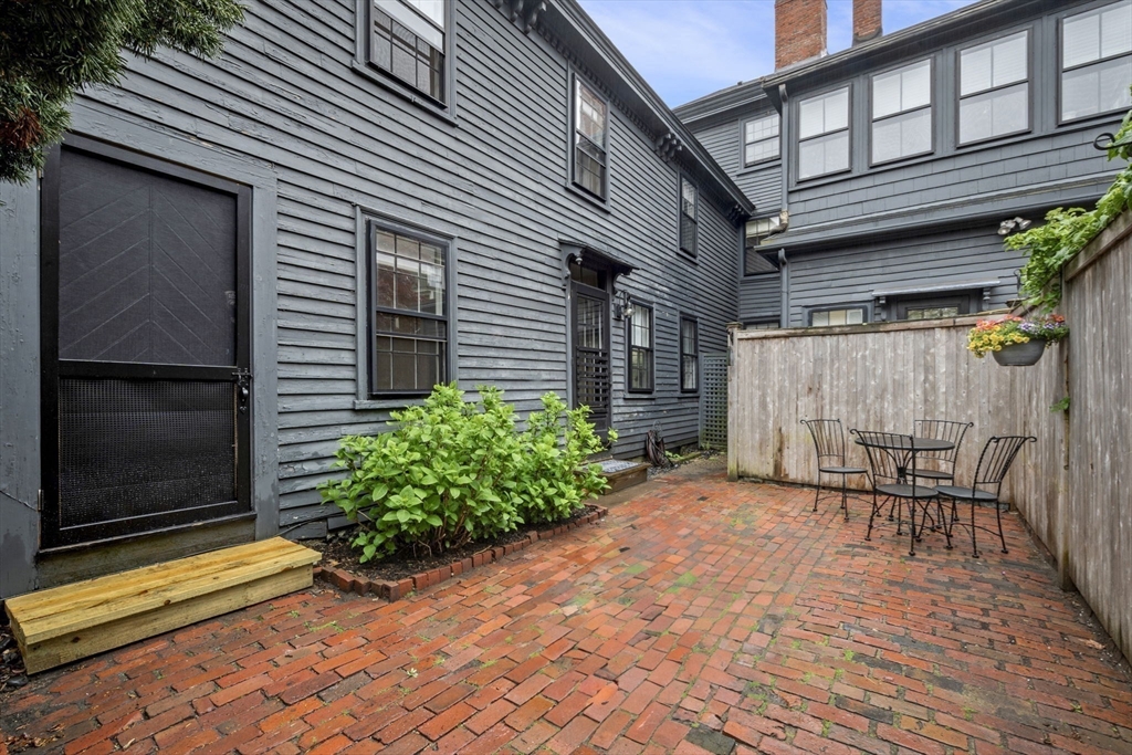 112 Federal Street, Unit 1 Salem, MA 01970 - Photo 40 of 42 a backyard of a house with table and chairs