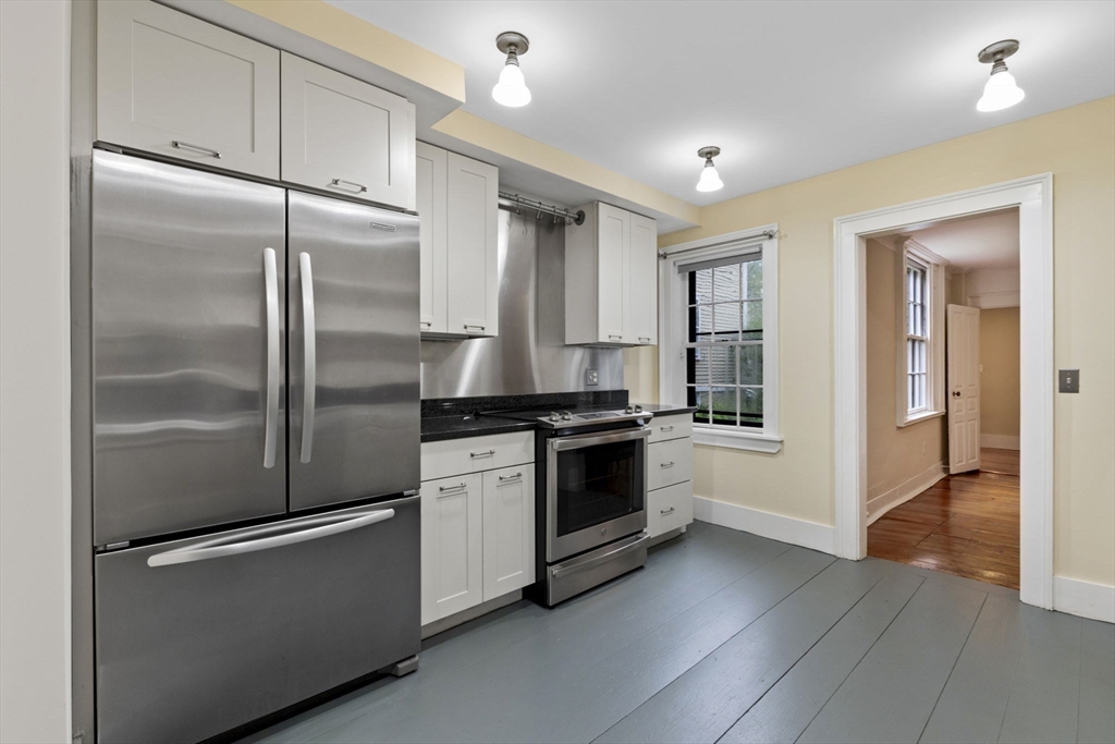 112 Federal Street, Unit 1 Salem, MA 01970 - Photo 6 of 42 a kitchen with stainless steel appliances granite countertop a refrigerator and a stove