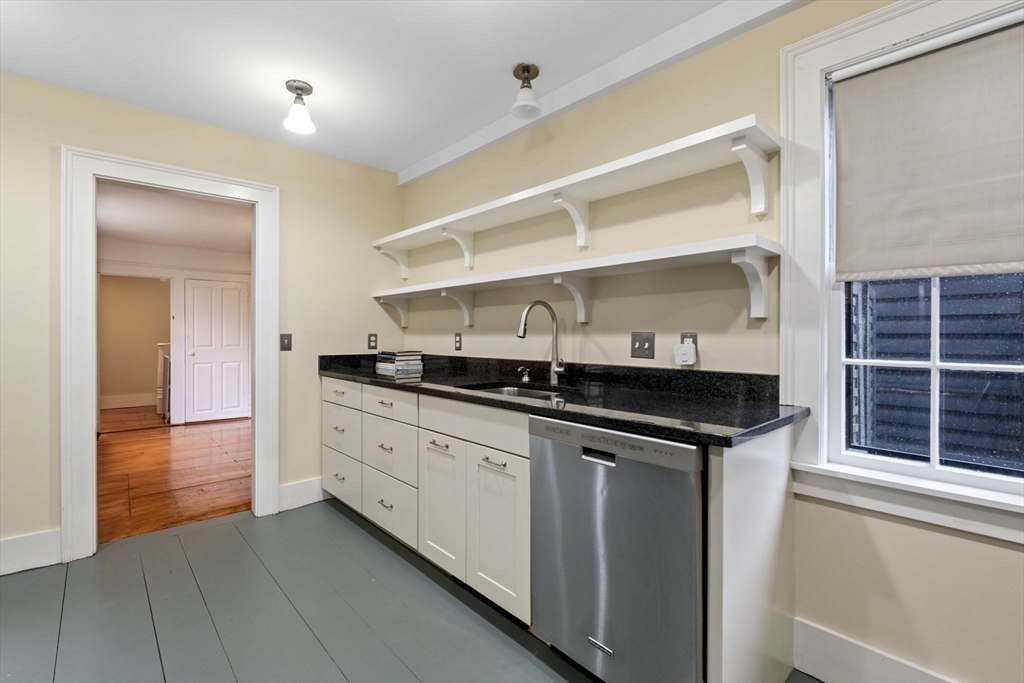 112 Federal Street, Unit 1 Salem, MA 01970 - Photo 7 of 42 a kitchen with granite countertop a sink and cabinets