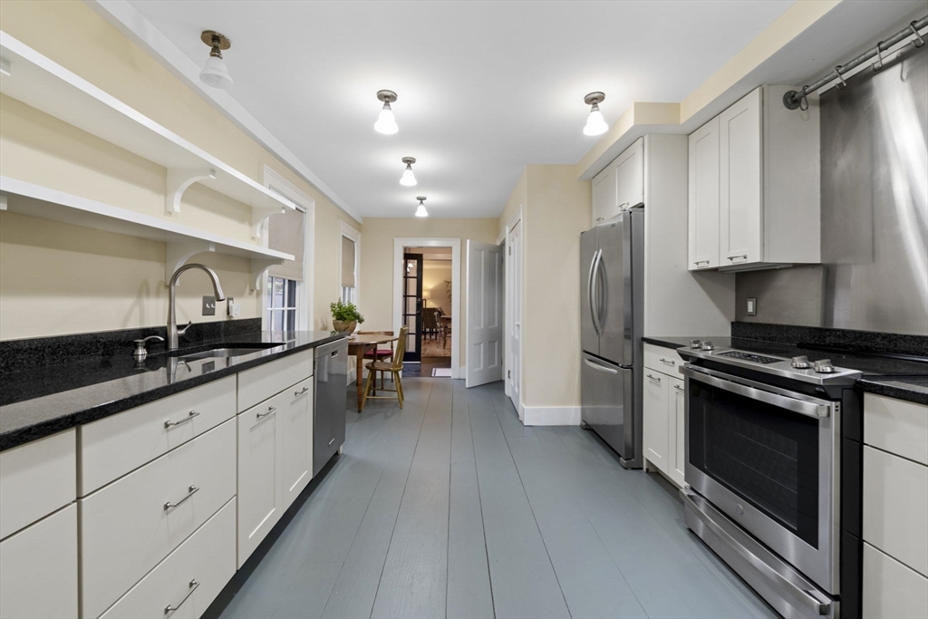 112 Federal Street, Unit 1 Salem, MA 01970 - Photo 9 of 42 a modern kitchen with stainless steel appliances granite countertop a stove and a sink