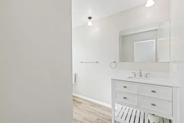a bathroom with a sink a mirror and vanity