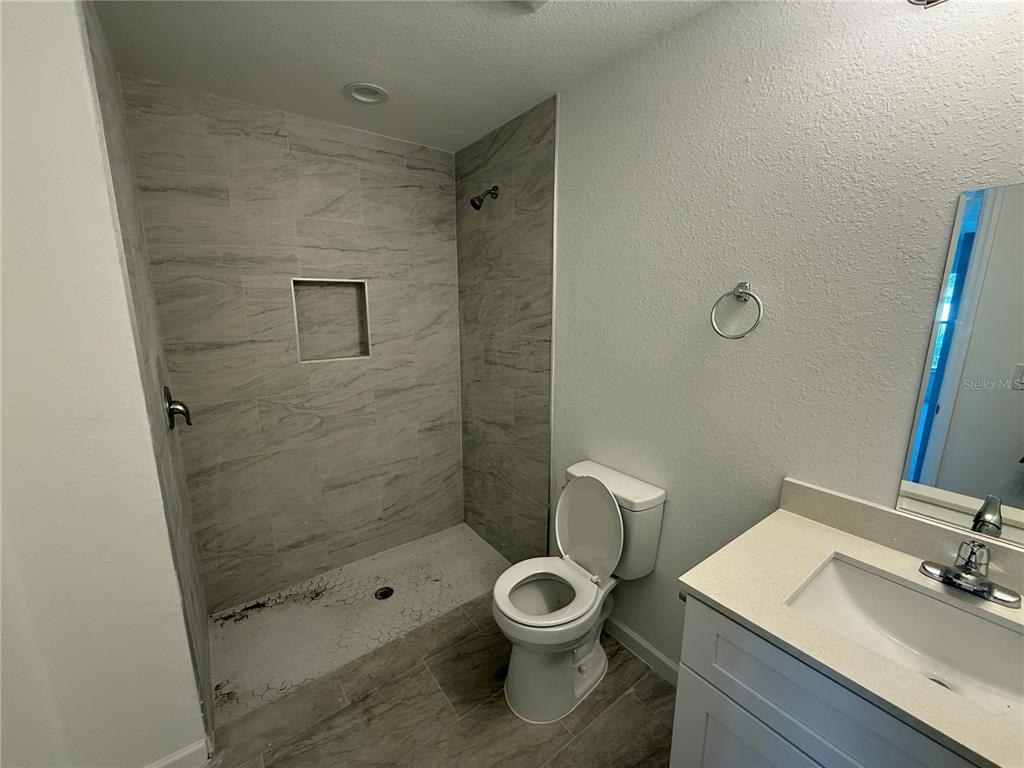 1288 Nackman Road North Port, FL 34288 - Photo 12 of 29 a bathroom with a toilet a sink and shower